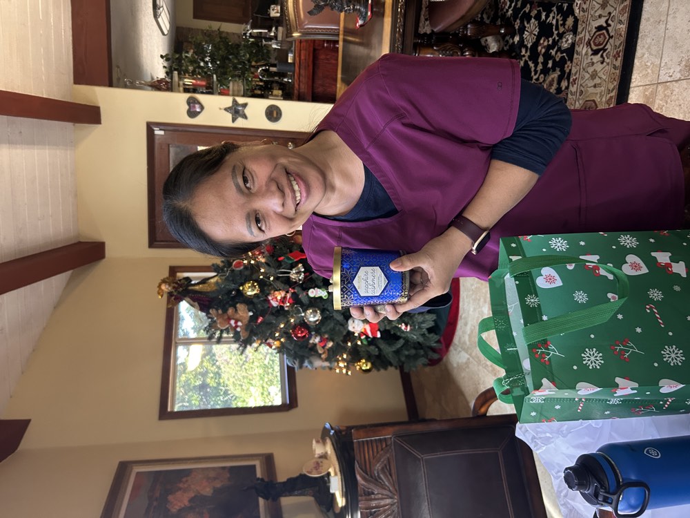 A caregiver holding a holiday gift for a client
