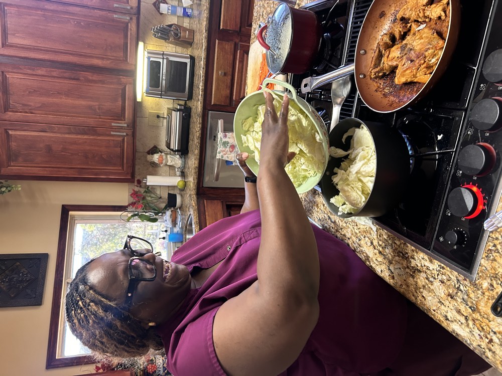 A caregiver laughing while preparing a meal